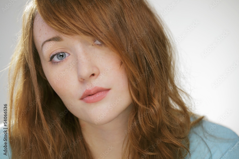 Head shot of young woman with red hair