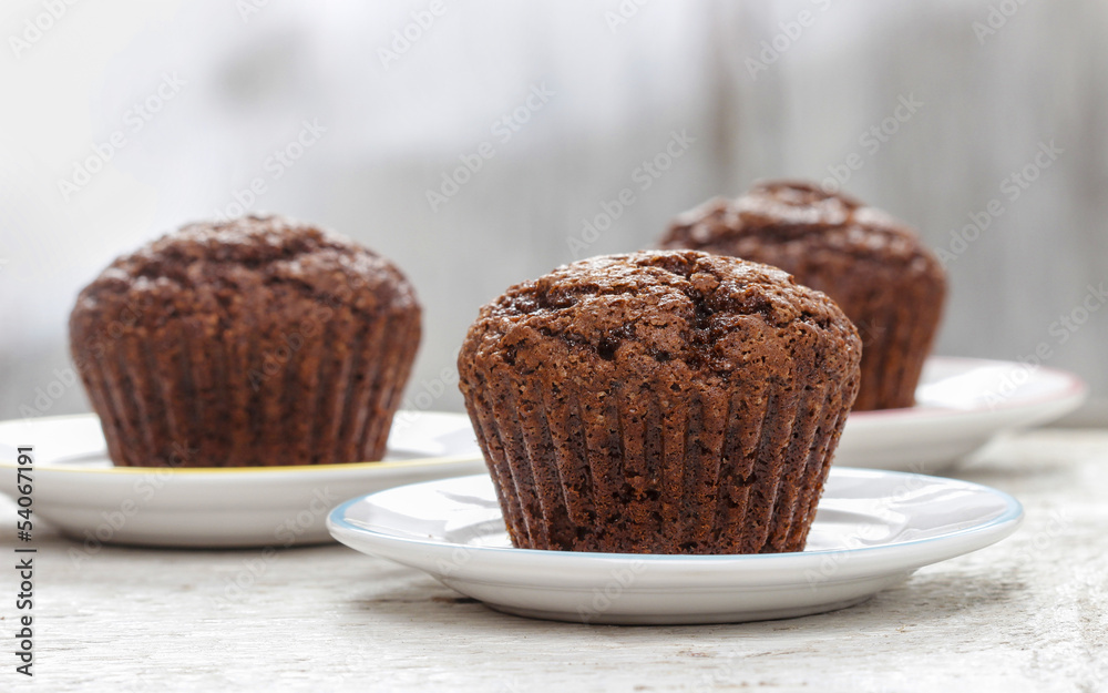 Chocolate muffin on white plate Chocolate muffin on white plate