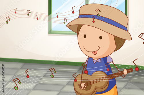 A boy playing with the guitar near the window