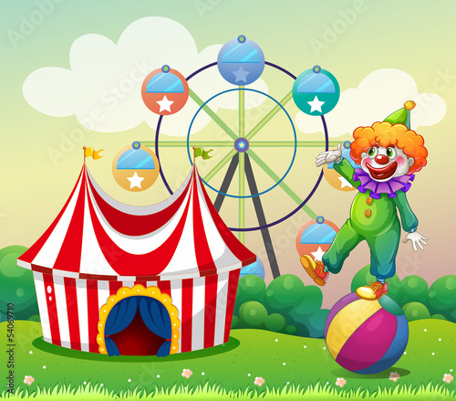 A clown standing above the ball at the carnival © GraphicsRF