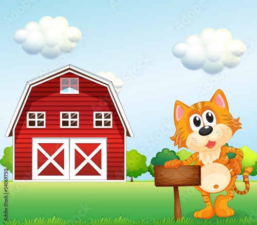 A cat holding an empty signboard with a barn at the side