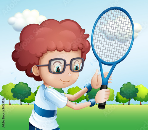 A young boy playing tennis