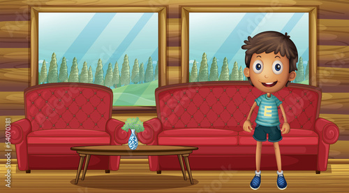 A boy standing inside the house