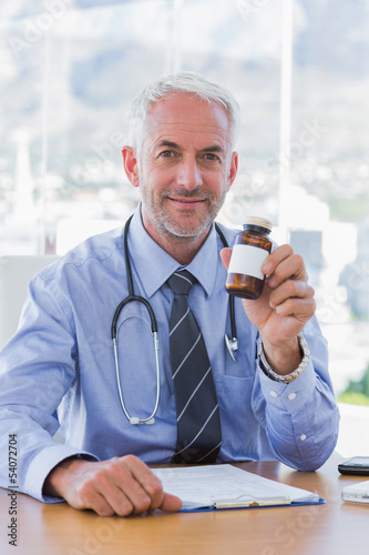 Attractive doctor holding medicine jar