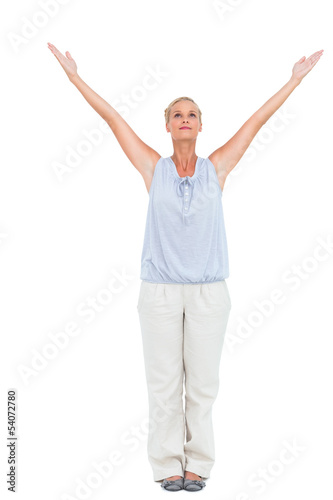 Blonde woman standing with arms outstretched