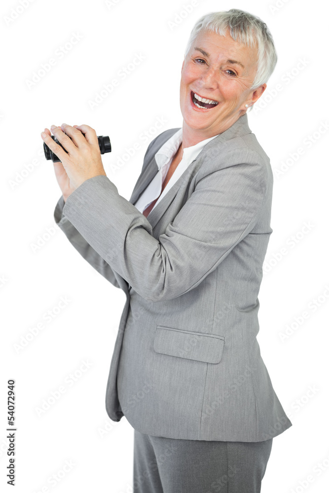 Smiling businesswoman with binoculars Smiling businesswoman with binoculars