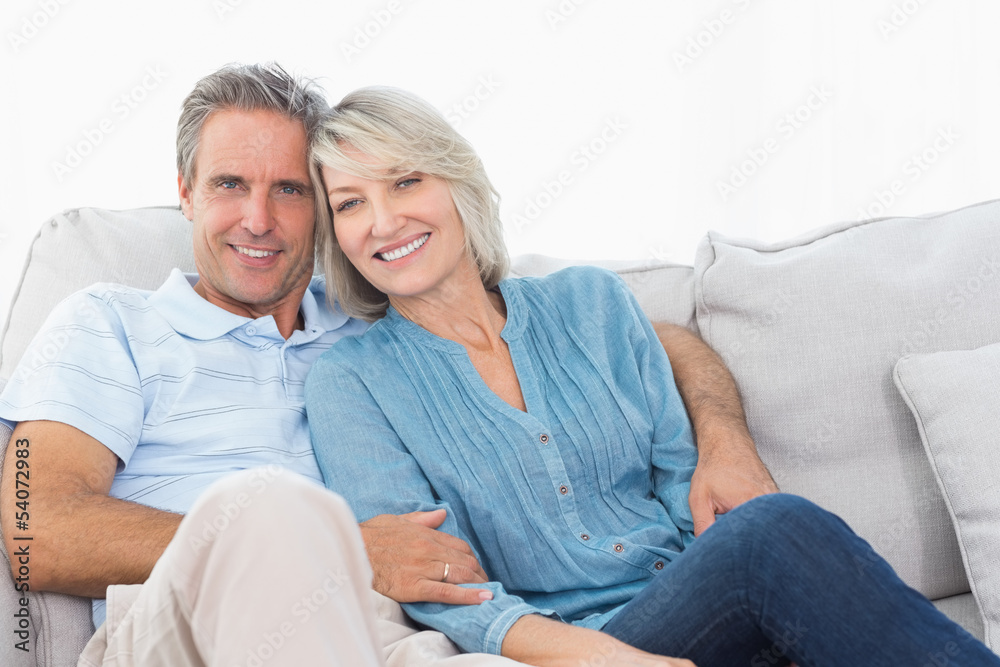 Cheerful couple on their couch Cheerful couple on their couch