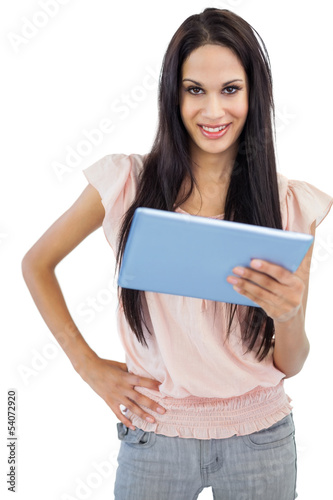 Smiling young woman posing with her tablet pc