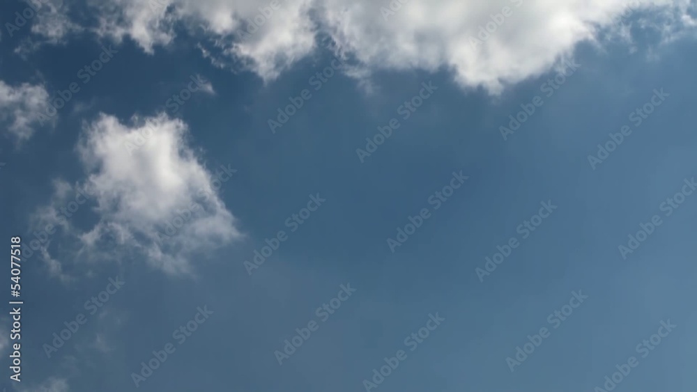 Time lapse clip of white fluffy clouds over blue sky Time lapse clip of white fluffy clouds over blue sky