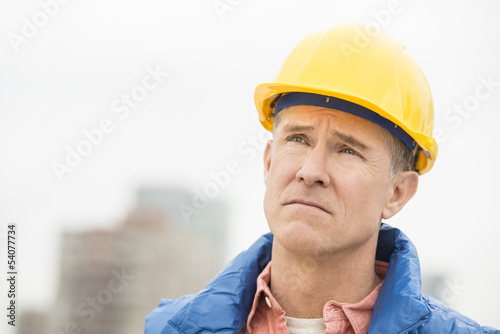 Tired Worker Looking Away At Construction Site