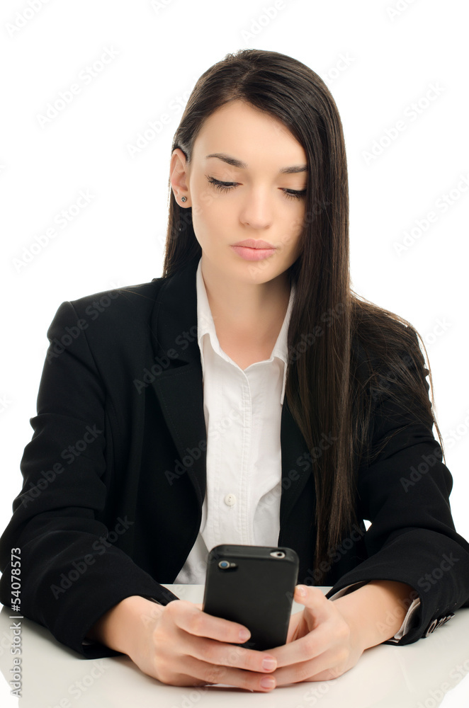 Beautiful business woman using a mobile phone at work