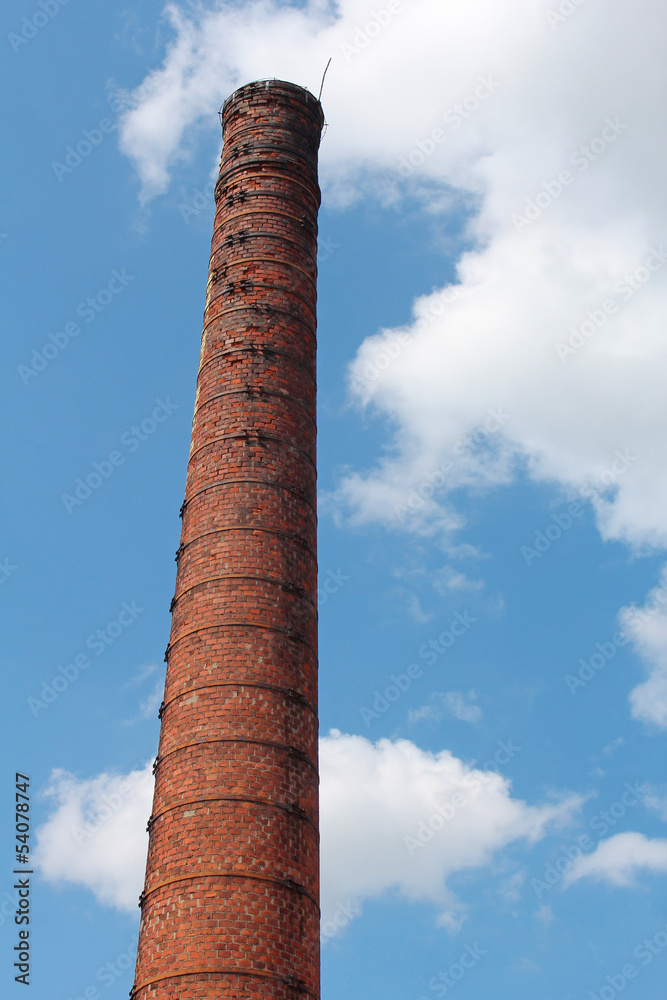 industrial old brick chimney on blue sky