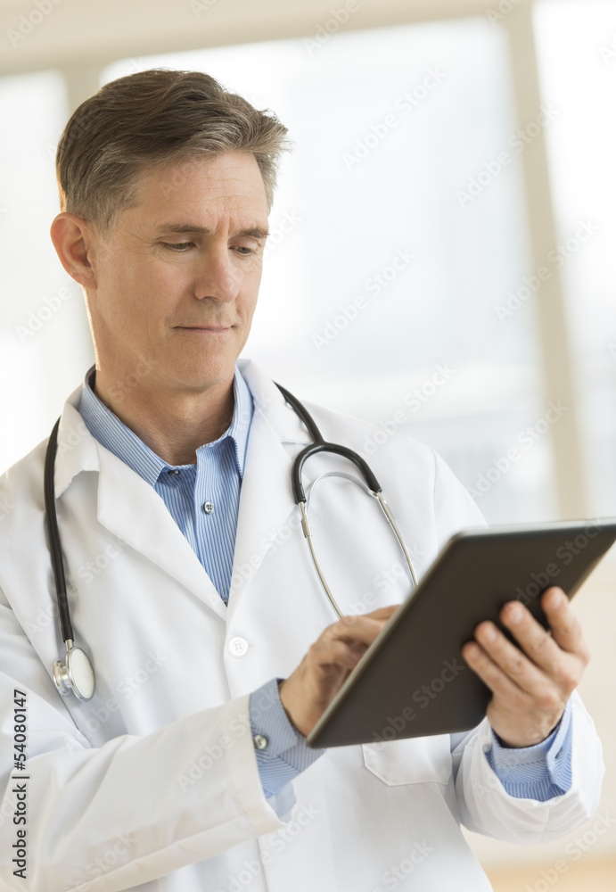 Doctor Using Digital Tablet In Clinic Doctor Using Digital Tablet In Clinic