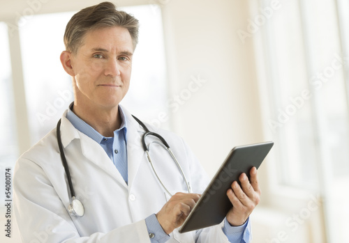 Portrait Of Confident Doctor Holding Digital Tablet