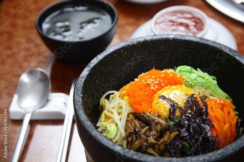 Korean cuisine : bibimbap in a heated stone bowl
