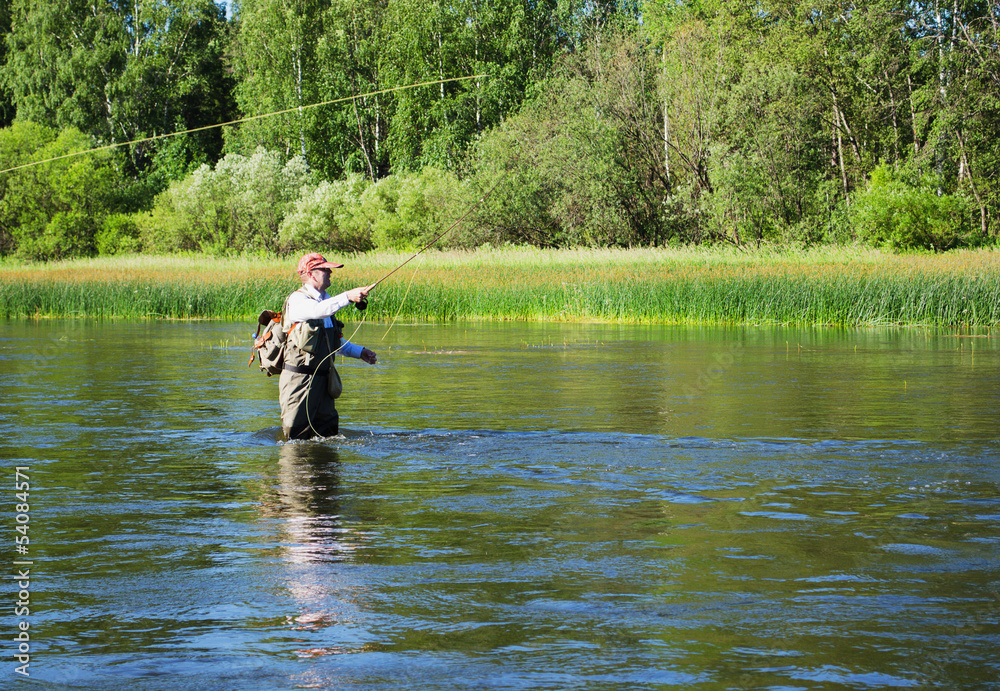 Fisherman catches of chub fly fishing in the Chusovaya river Fisherman catches of chub fly fishing in the Chusovaya river