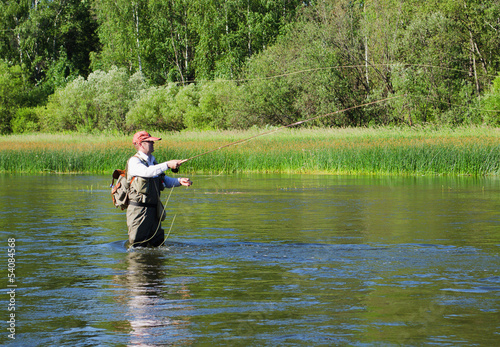 Fisherman catches of chub  fly fishing in the Chusovaya river
