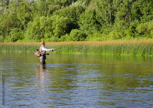 Fisherman catches of chub fly fishing in the Chusovaya river