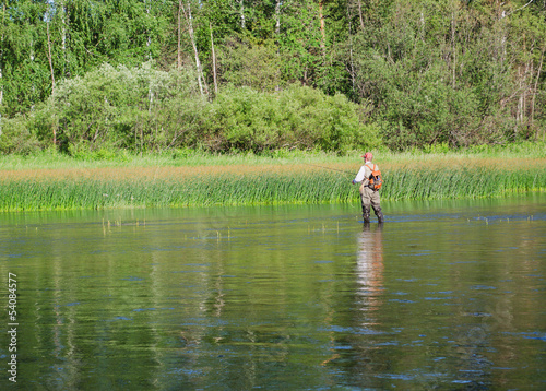 Fisherman catches of chub fly fishing in the Chusovaya river © Serg_Zavyalov_photo