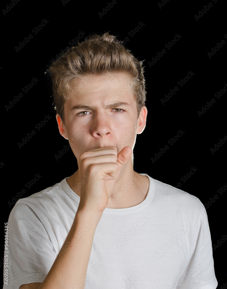 Cute teenager boy coughing, isolated on black Cute teenager boy coughing, isolated on black