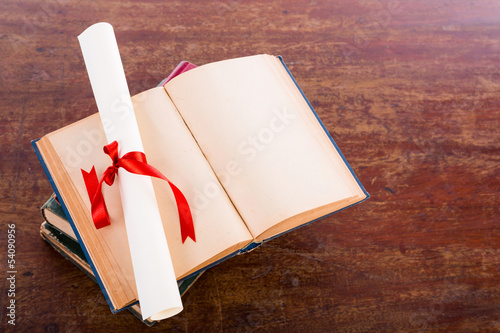 Bilde på lerret Diploma with old book isolated  on a white background.