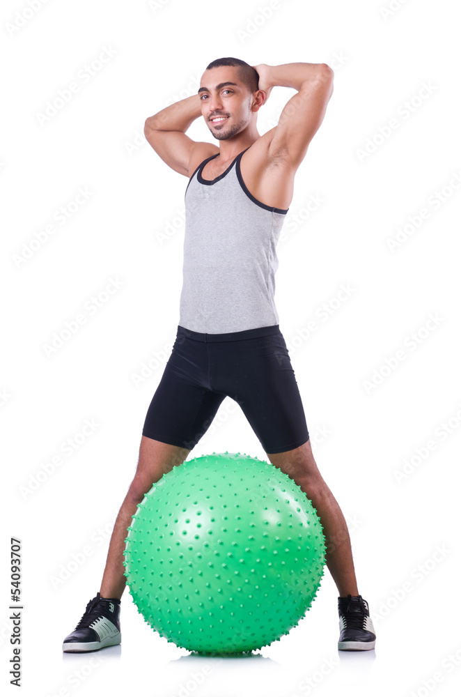 Man with swiss ball doing exercises on white Man with swiss ball doing exercises on white
