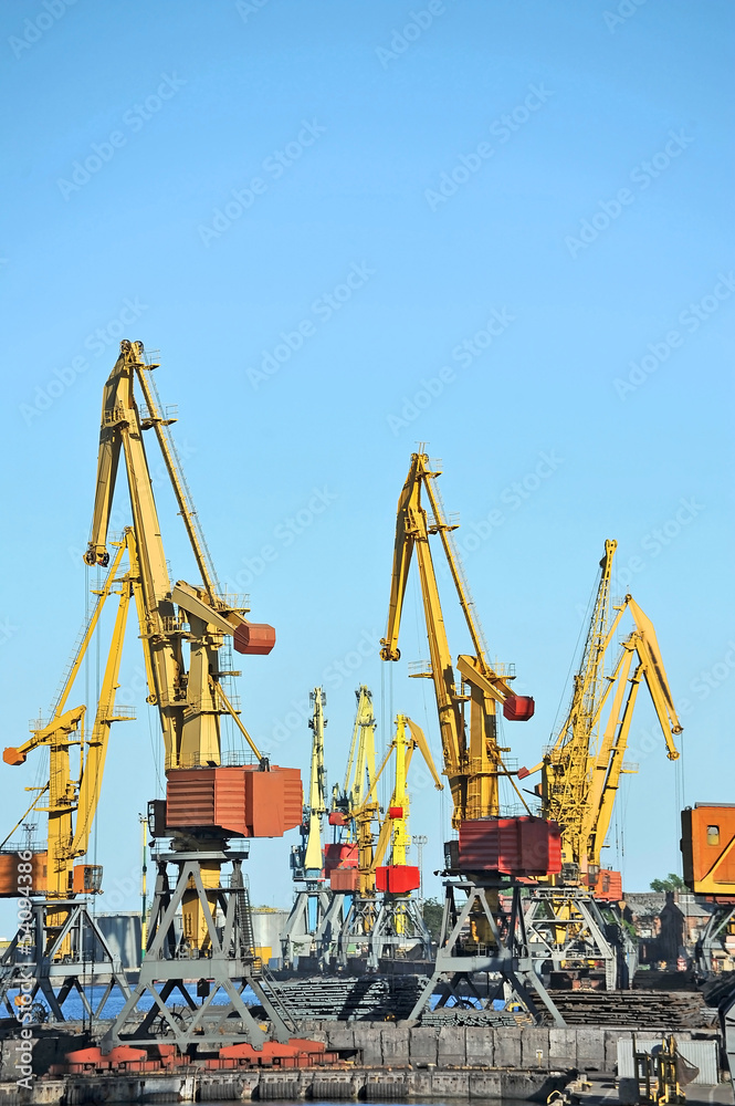 Port cargo crane over blue sky background