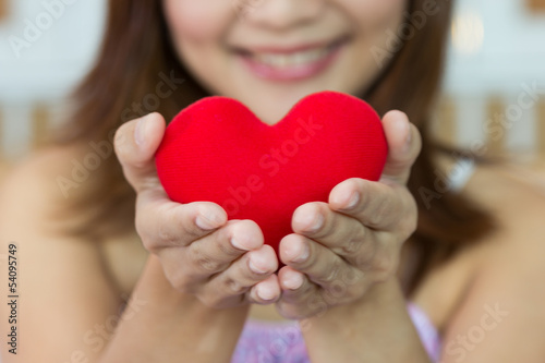 Closeup women happiness with heart shape in hands