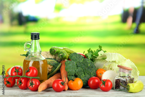 Fototapeta Naklejka Na Ścianę i Meble -  Fresh vegetables in basket on wooden table on natural