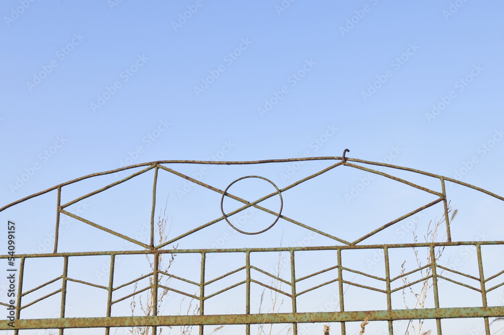 Fototapeta premium Wrought iron door decoration in the blue sky