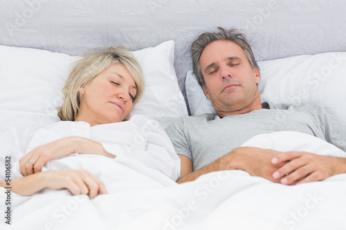 Couple sleeping peacefully in their bed