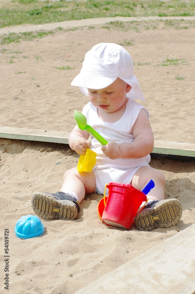 baby age of 9 months plays in sandpit baby age of 9 months plays in sandpit