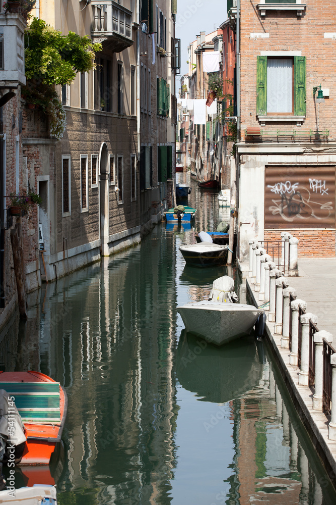 View of ancient buildings and narrow canal in Venice