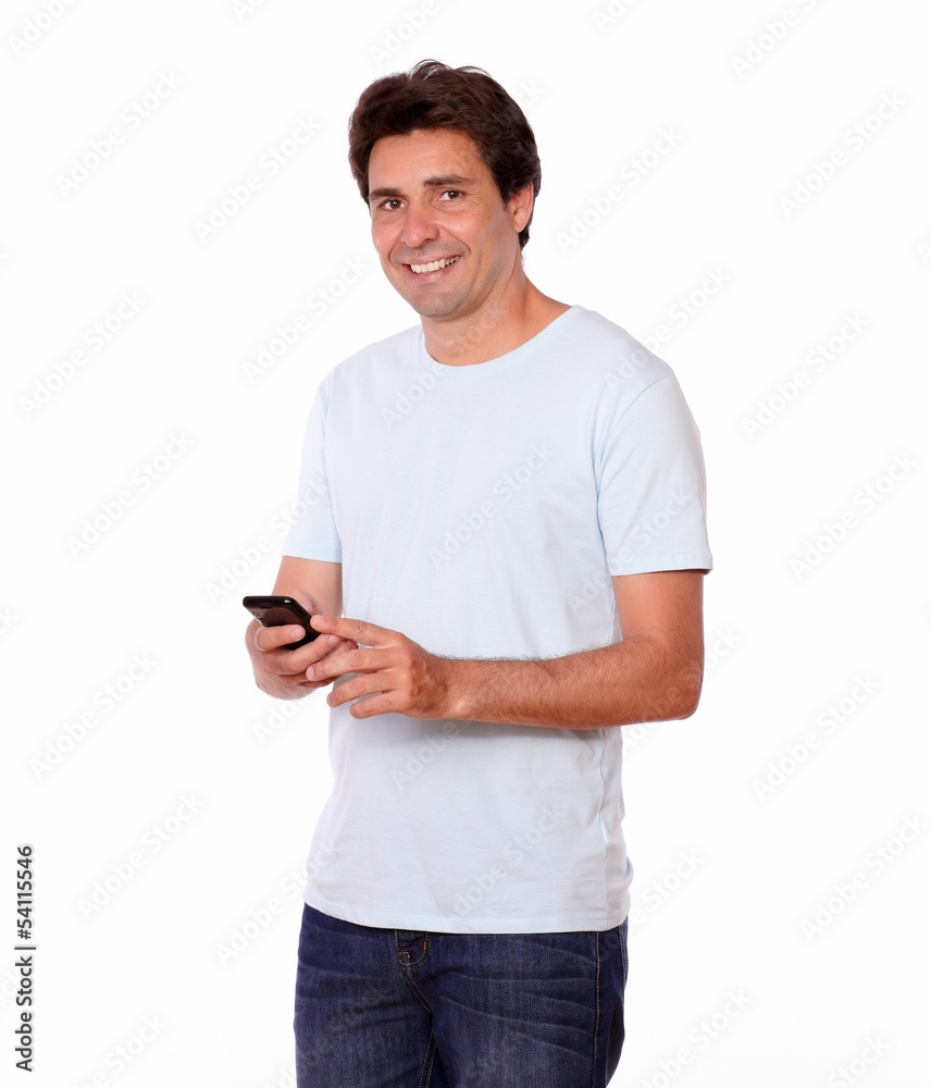 Charming male sending a message on cellphone Charming male sending a message on cellphone