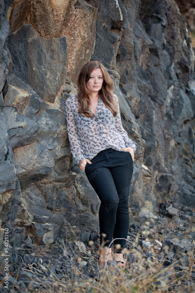 Blonde beauty posing on rock Blonde beauty posing on rock