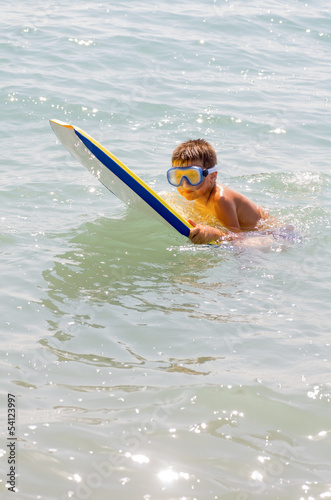 Photography child surfing on the beach 6