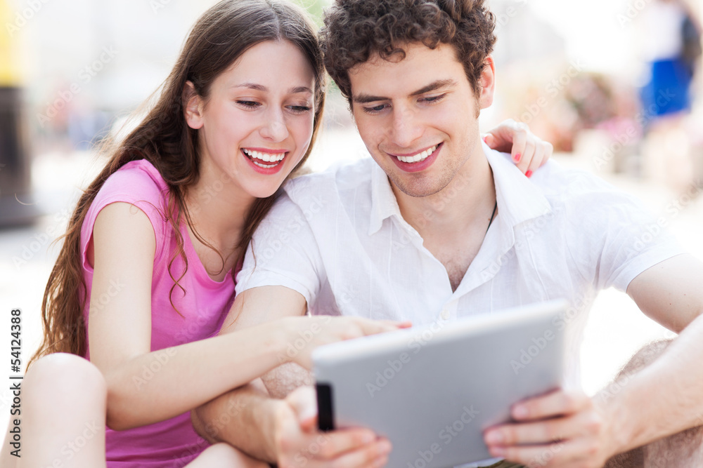 Young couple looking at digital tablet Young couple looking at digital tablet