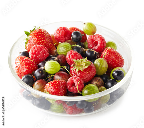 Bowl of fresh ripe berries on white background