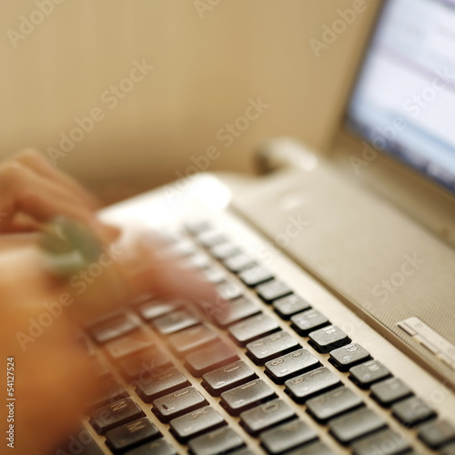 Young woman working on laptop photo