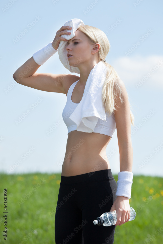 Tired Woman Wiping Face With Towel After Exercise Tired Woman Wiping Face With Towel After Exercise