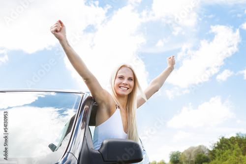 Woman Raising Hand Out Of Car Window