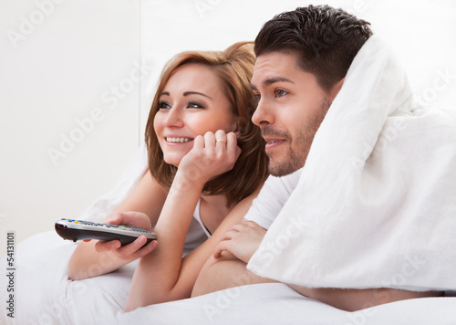 Young couple watching television