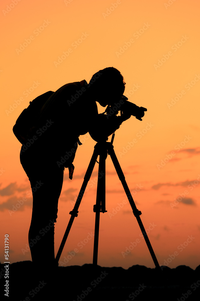 Photographer on work in sunset- Silhouette