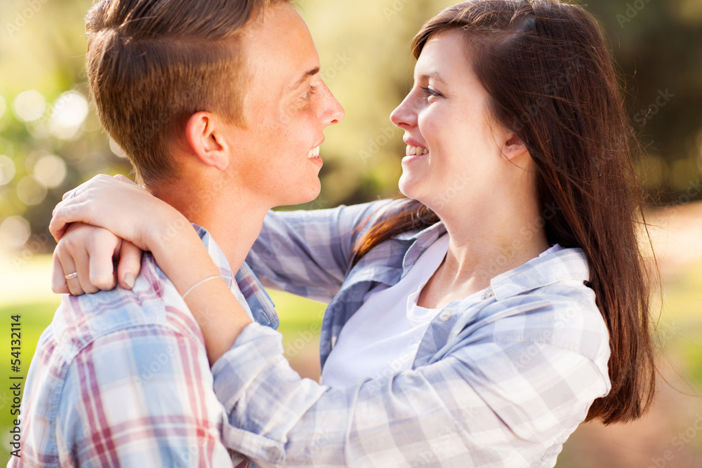 teenage couple looking at each other with love teenage couple looking at each other with love