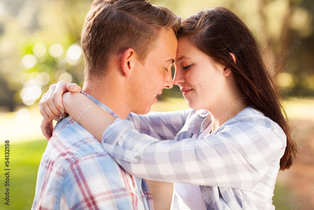 Obraz premium young teenage couple hugging with eyes closed