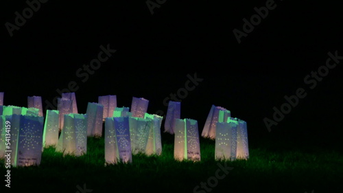 Paper bag candles glowing in the dark photo