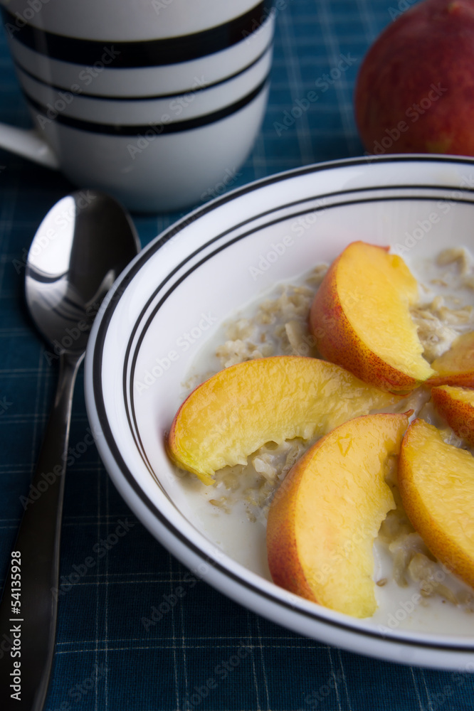 Peaches oatmeal on a blue tablecloth served Peaches oatmeal on a blue tablecloth served