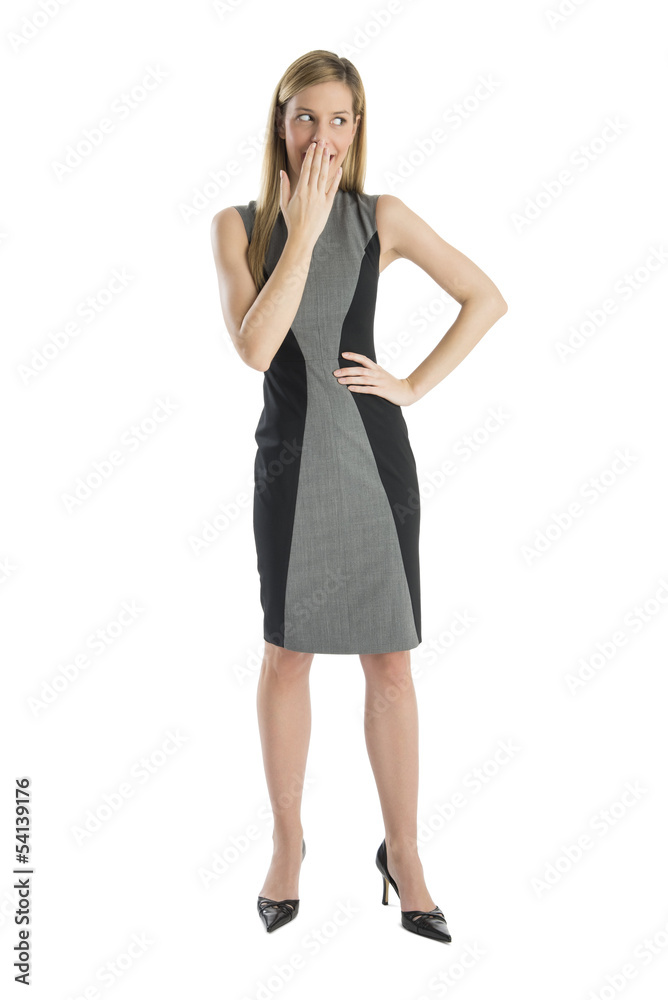 Businesswoman Looking Away While Covering Mouth With Hand Businesswoman Looking Away While Covering Mouth With Hand