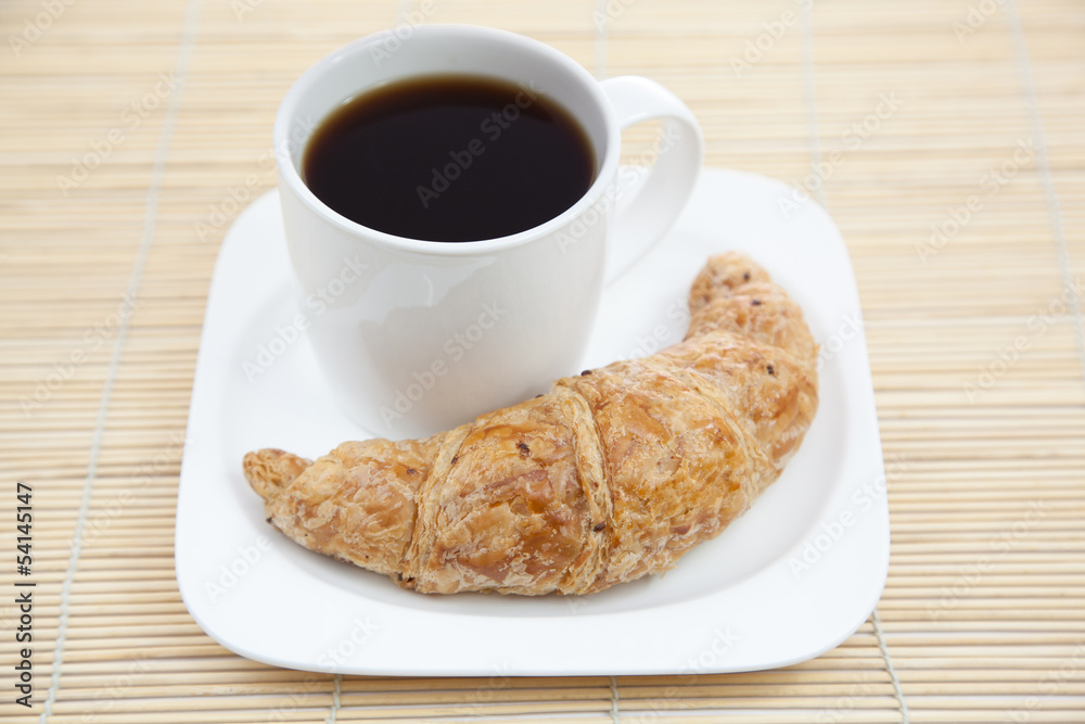 Croissant and a cup of coffee Croissant and a cup of coffee