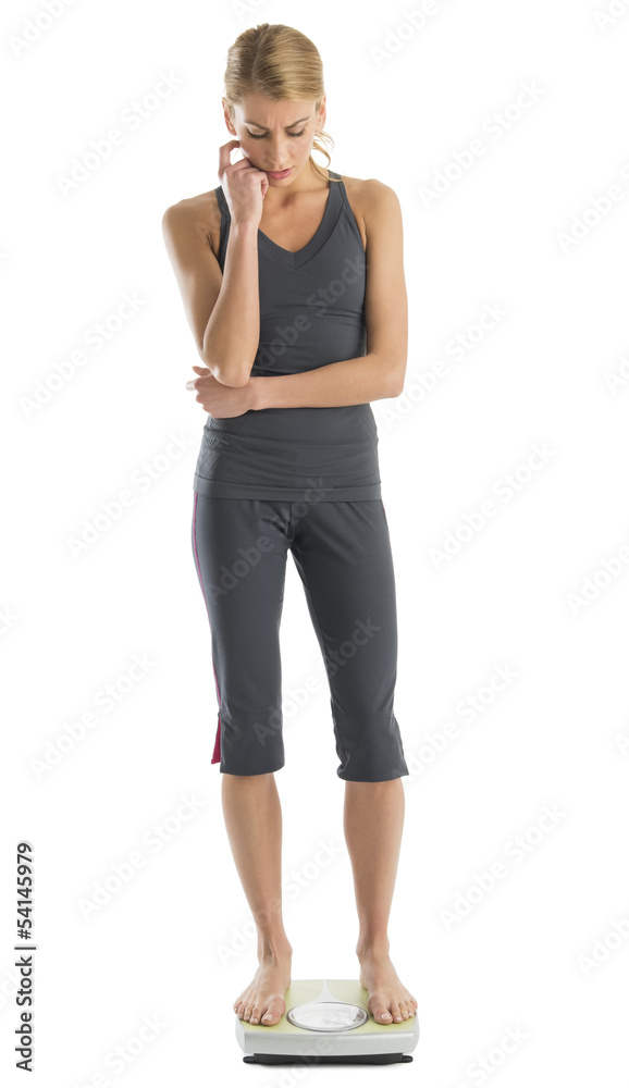 Tensed Woman Weighing Herself On Weight Scale Tensed Woman Weighing Herself On Weight Scale